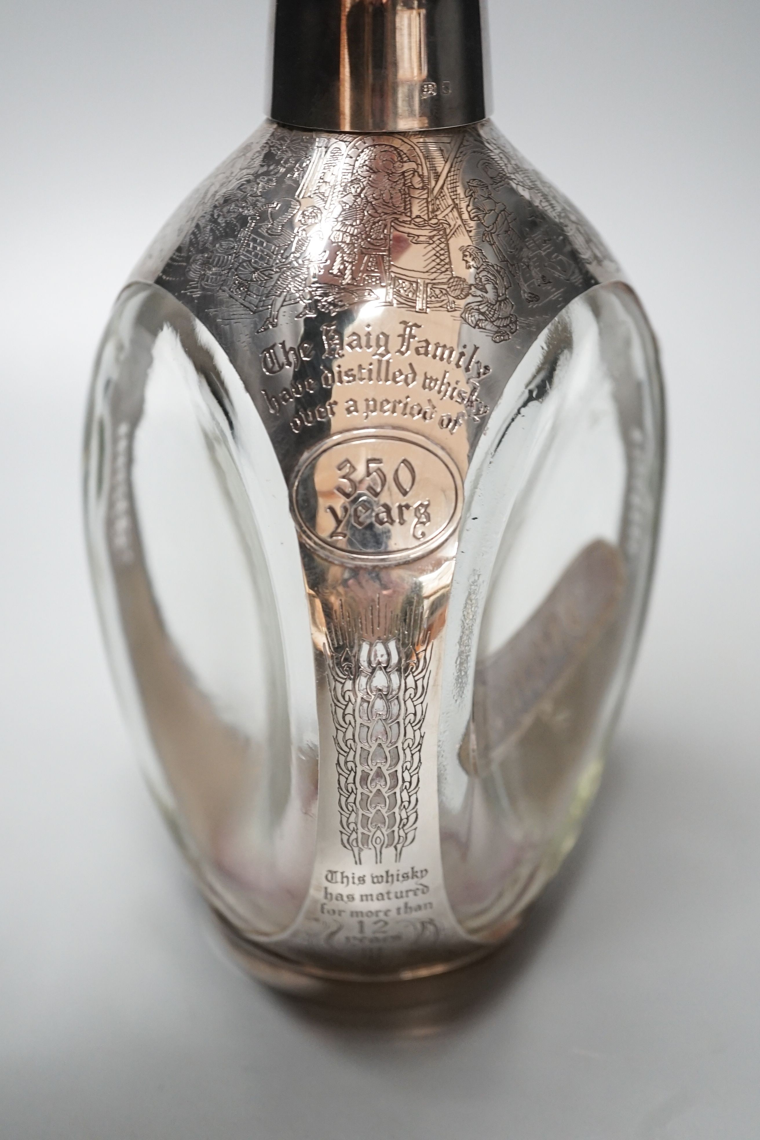 A modern engraved silver mounted glass commemorative Haig Whisky decanter, London, 1977, 22.7cm.